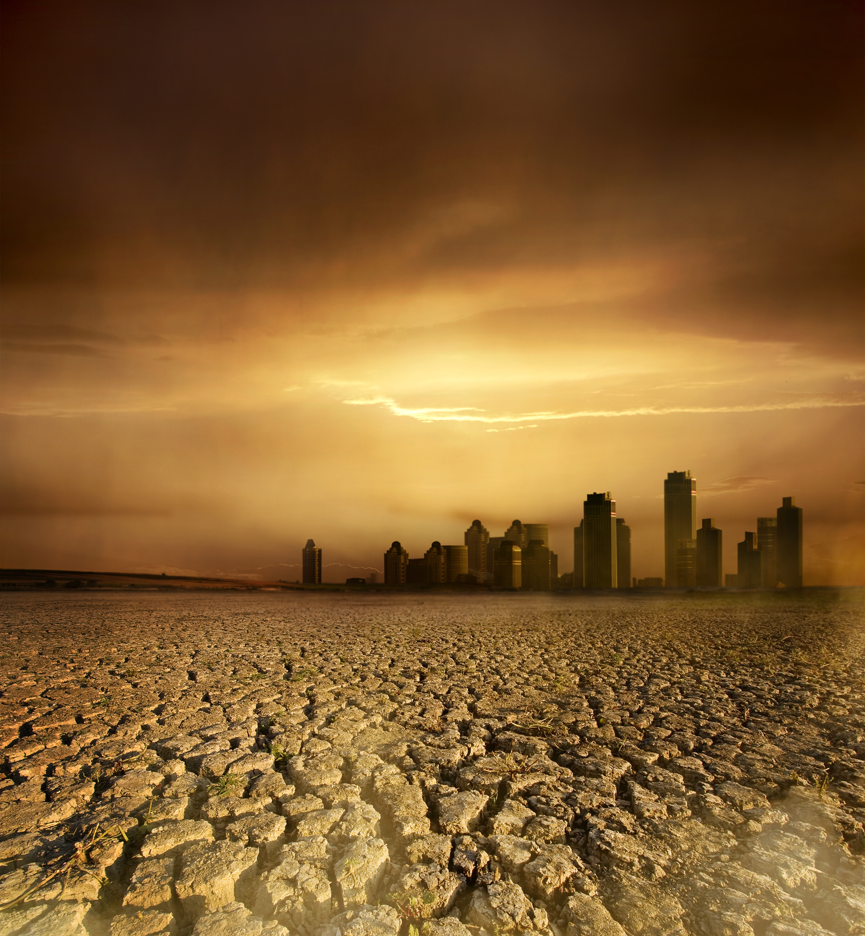 Global Warming and pollution theme with cracked land and the cityscape
